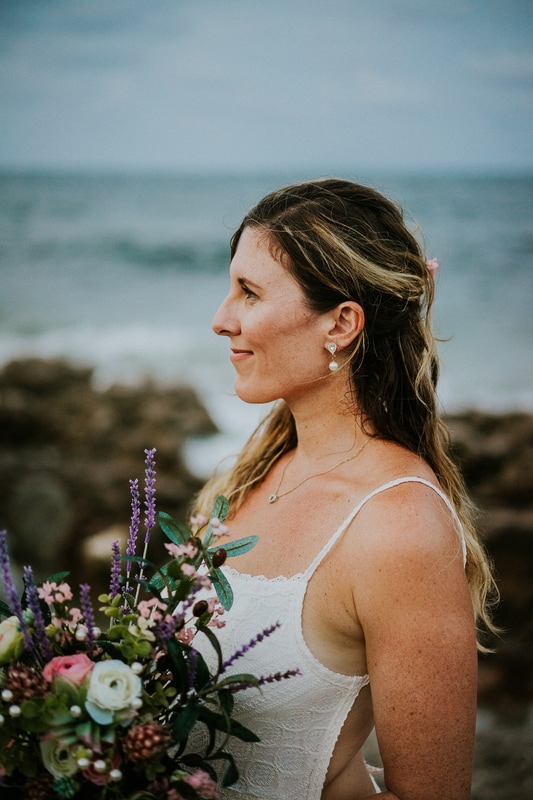 Coral Cove beach elopement bridal portrait holding bouquet profile