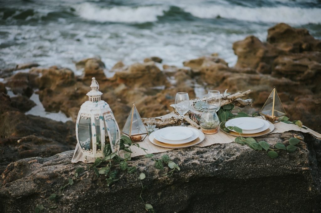 Coral Cove beach elopement wedding details on rocky beach with waves behind