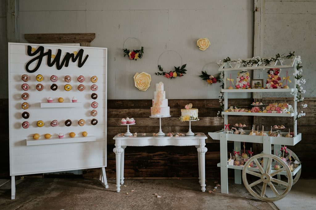 Pink Lemonade photoshoot dessert table, wedding cake, donut wall, dessert cart at Twisted Oak Farm Vero Beach FL barn wedding