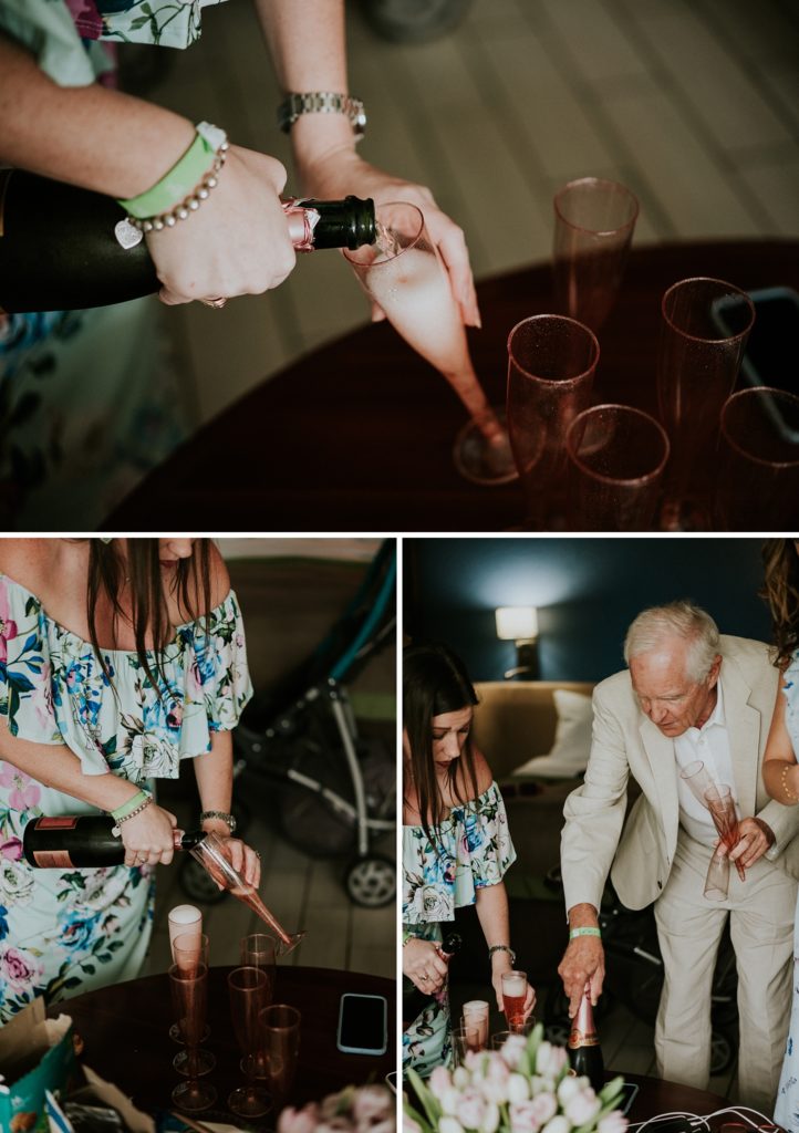 Friend and father of the bride pour champagne into pink flutes