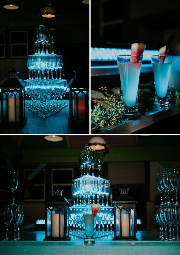 Blue glowing light illuminates empy glasses next to signature cocktail watermelon martinis