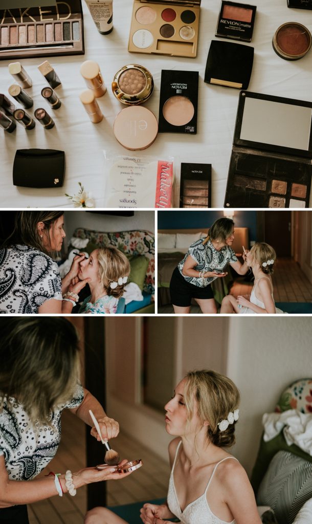 Bride's makeup collection and her aunt applying makeup to the bride's face in a hotel room