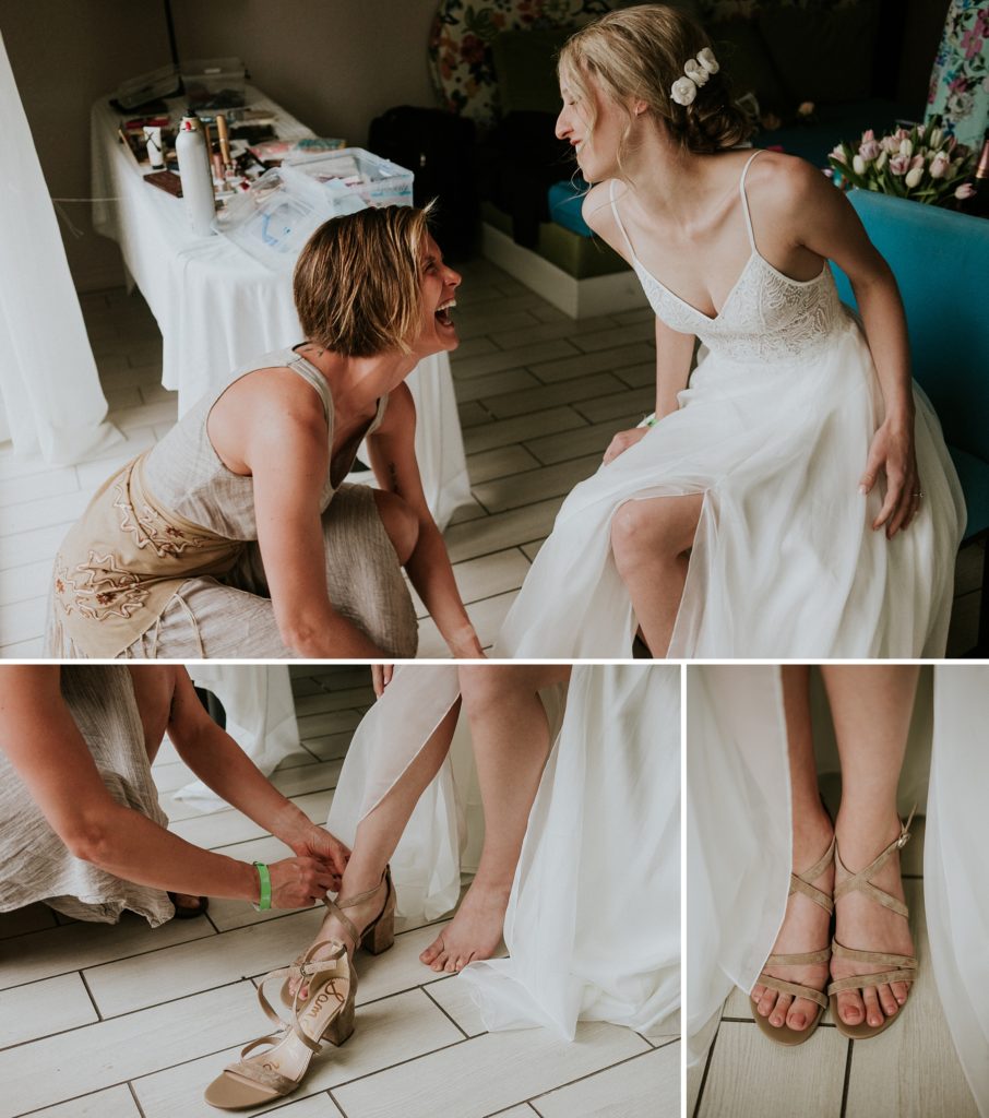 Candids of friend putting on bride's shoes while laughing