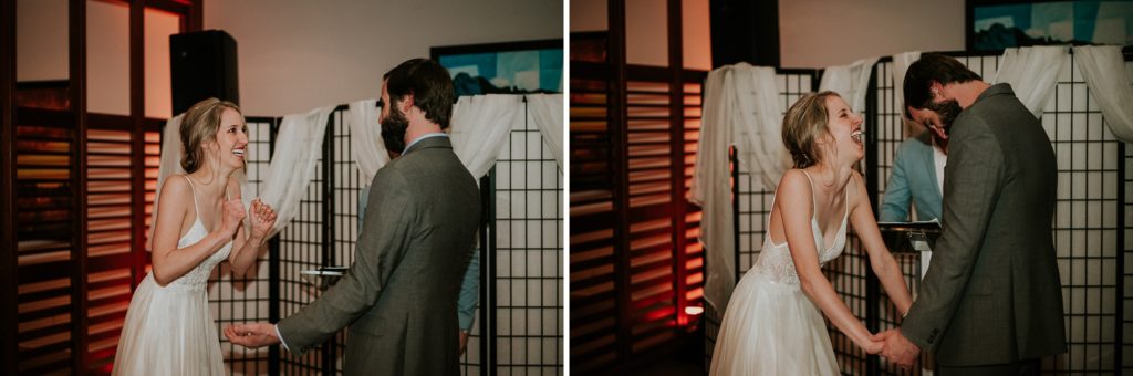 Bride and groom laugh and are excited to be married in indoor wedding ceremony