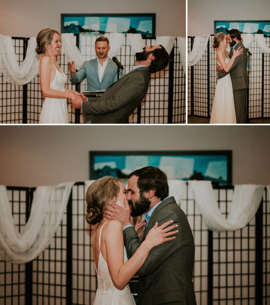 Bride and groom laugh before first kiss as husband and wife during indoor ceremony on rainy wedding day