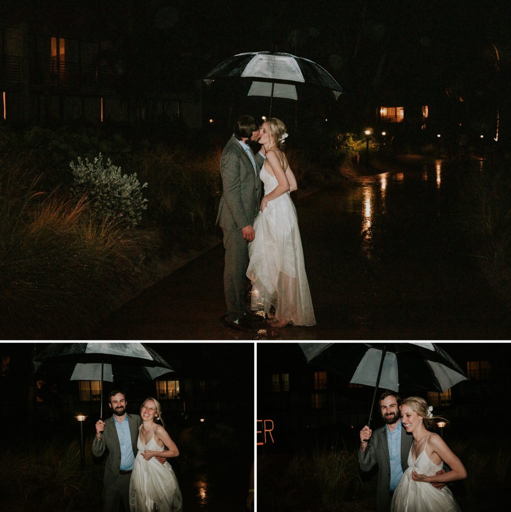 Bride and groom run through rainy wedding day at night holding an umbrella and kiss in the rain