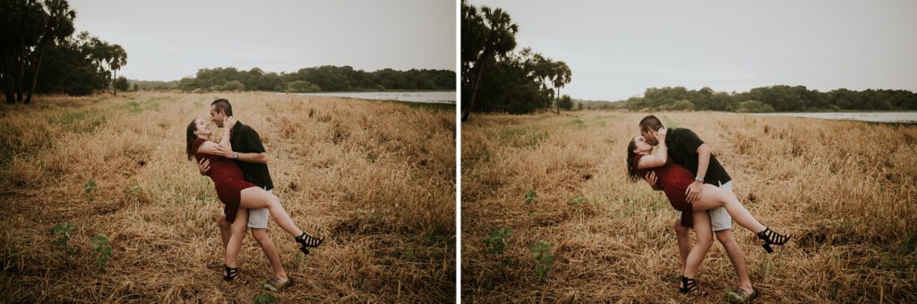 Engagement photos of couple laughing and dip kiss in golden field at Myakka river state park
