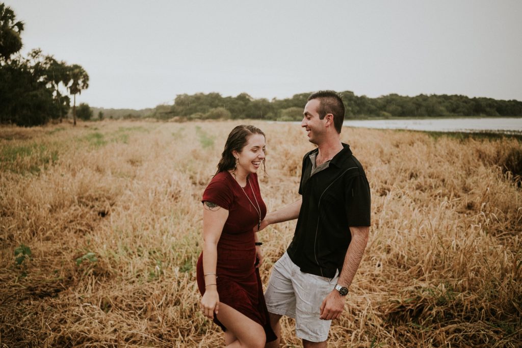 Engagement photos with couple laughing at Myakka River golden field