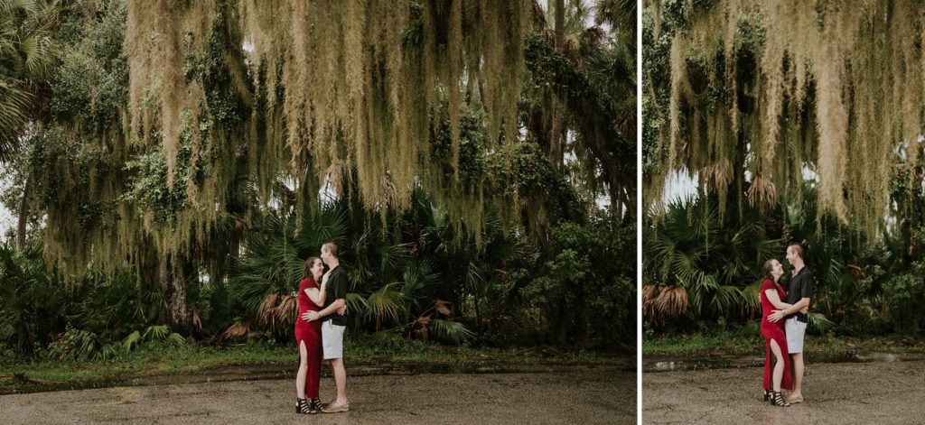 Engaged couple embraces under Spanish moss in Myakka river state park