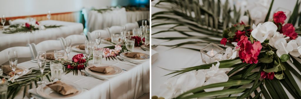 Palm frond and bougainvillea flower centerpieces on reception dinner tables