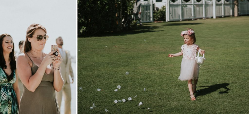 Wedding guest takes picture of the flower girl scattering petals