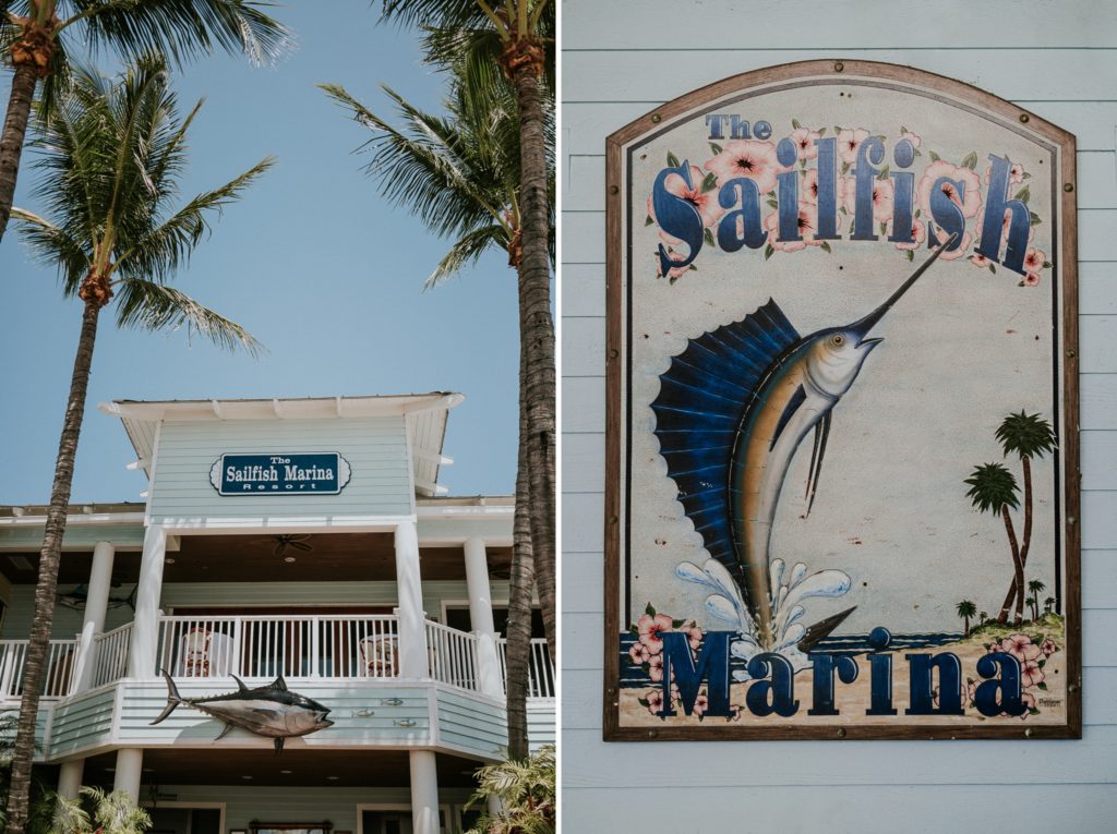 Palm trees frame Sailfish Marina Resort light blue wedding venue entrance, and this painted wall plaque sign featuring a blue fin sailfish hangs in the stairwell