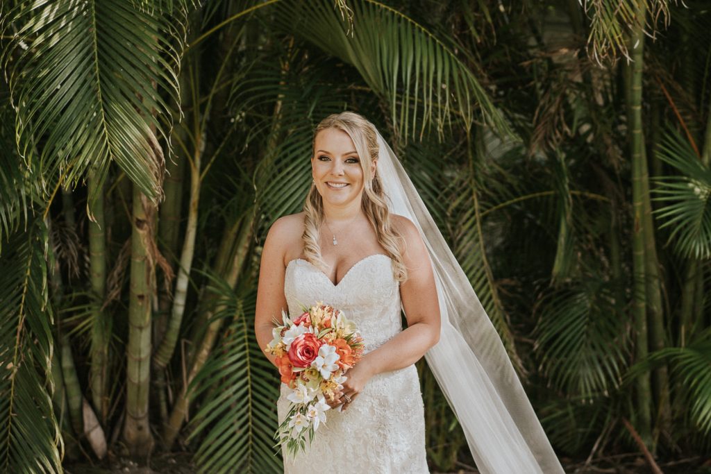 Singer Island bride wears strapless sweetheart neckline and long wedding veil with tropical wedding bouquet for Sailfish Marina wedding