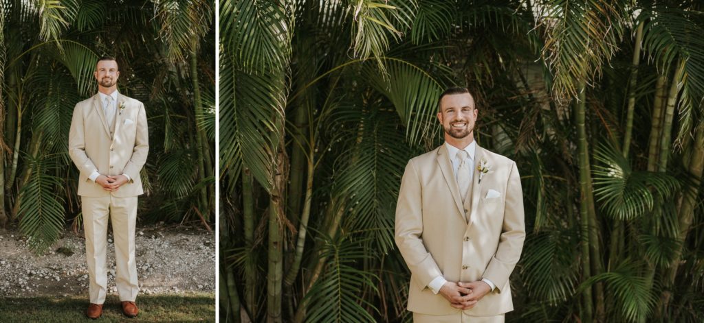 Singer Island wedding groom portraits wearing khaki suit standing in front of green palm fronds and bamboo