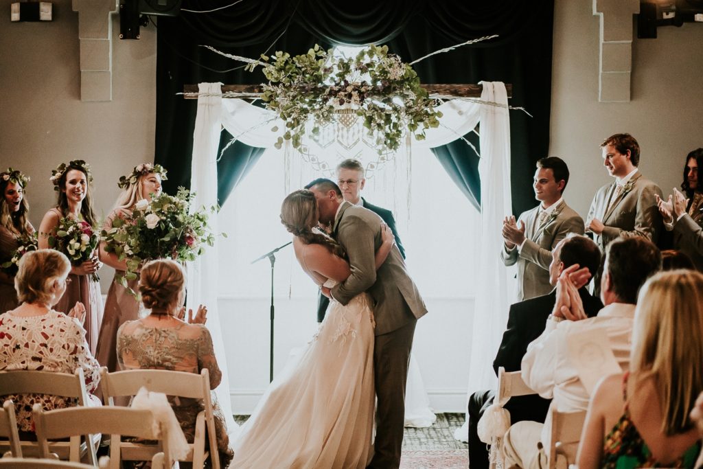 Bride and groom first kiss after ceremony