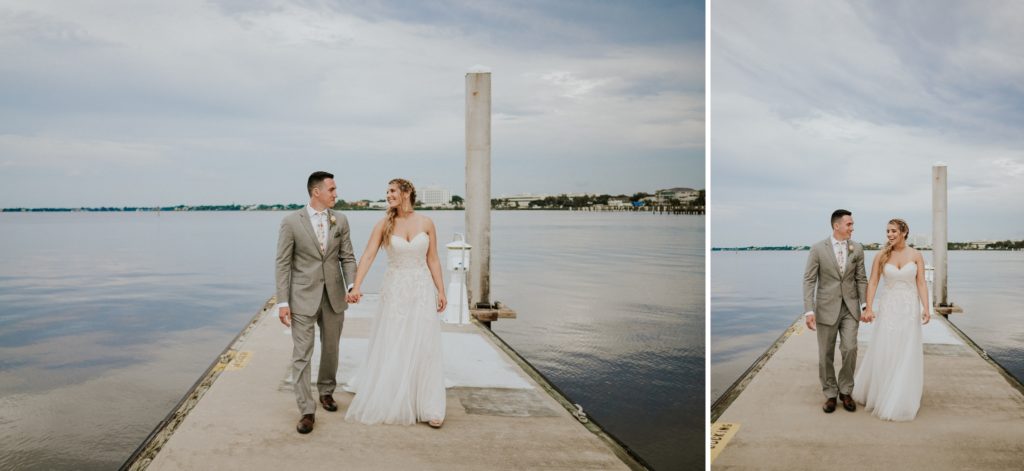 Florida elopement couple walks on boat dock on the St. Lucie River with cloudy sky