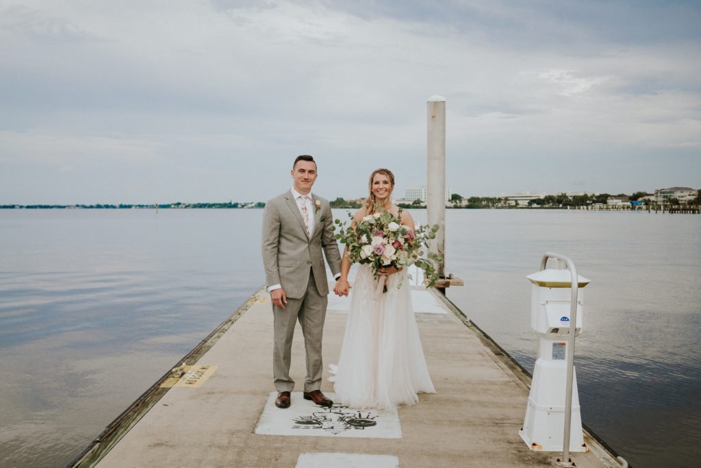 Downtown Stuart Florida elopement couple on boat dock on St. Lucie River with cloudy sky