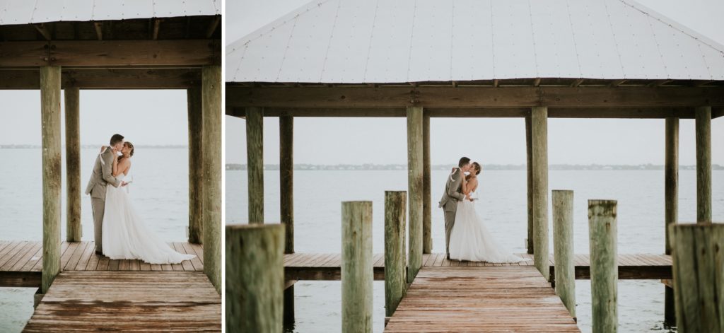 Bride and groom kiss under dock roof for House of Refuge elopement on the water