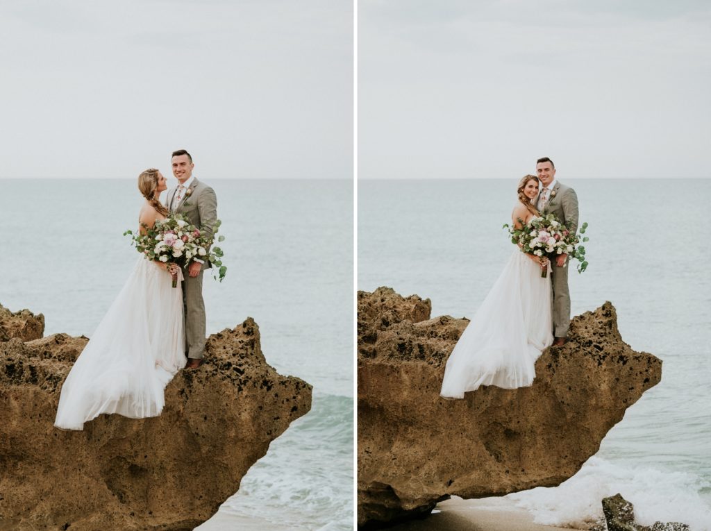 Bride and groom look at each other and smile at camera standing on limestone rock for House of Refuge elopement