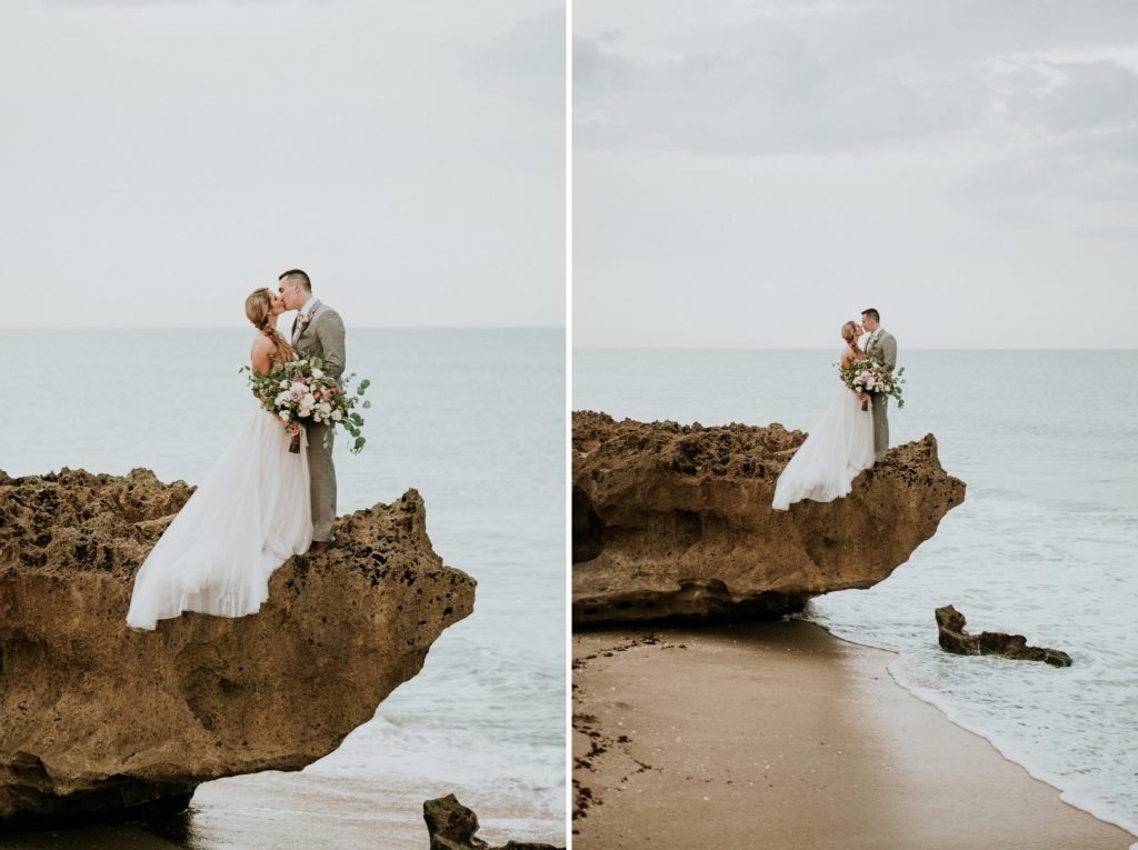 Wedding couple kiss standing on limestone rock over the water at House of Refuge elopement