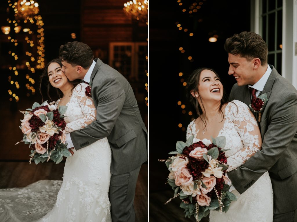Bride holding pink and red rose bouquet laughs as groom hugs her and kisses her cheek