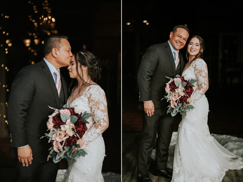 Dad kisses bride on forehead holding bouquet with pink and red flowers