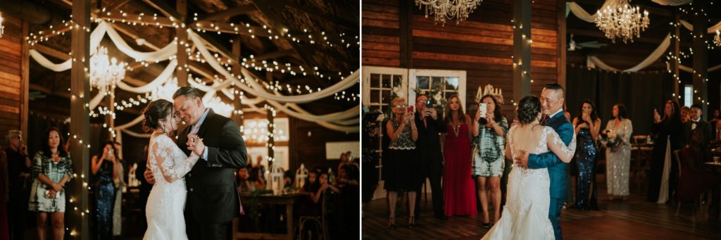 Bride dances with dad and step-dad at rustic Florida barn wedding venue with fairy lights above