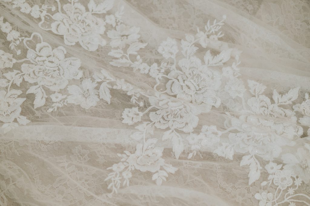 Close up of floral lace applique detail on Martina Liana designer wedding gown
