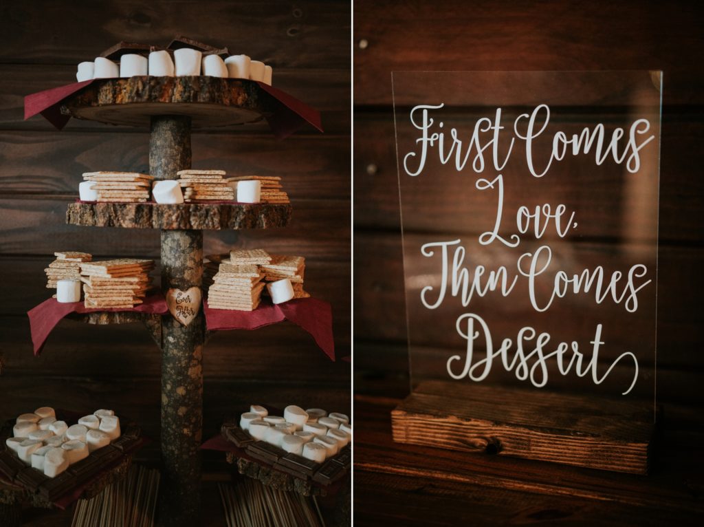 S'mores dessert table next to acrylic sign that says "First Comes Love Then Comes Dessert"