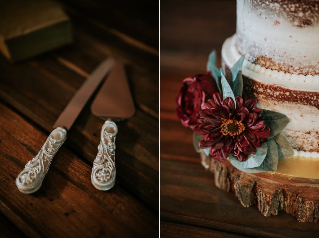 Details of cake knife and server handles with red flowers on wood base of cake