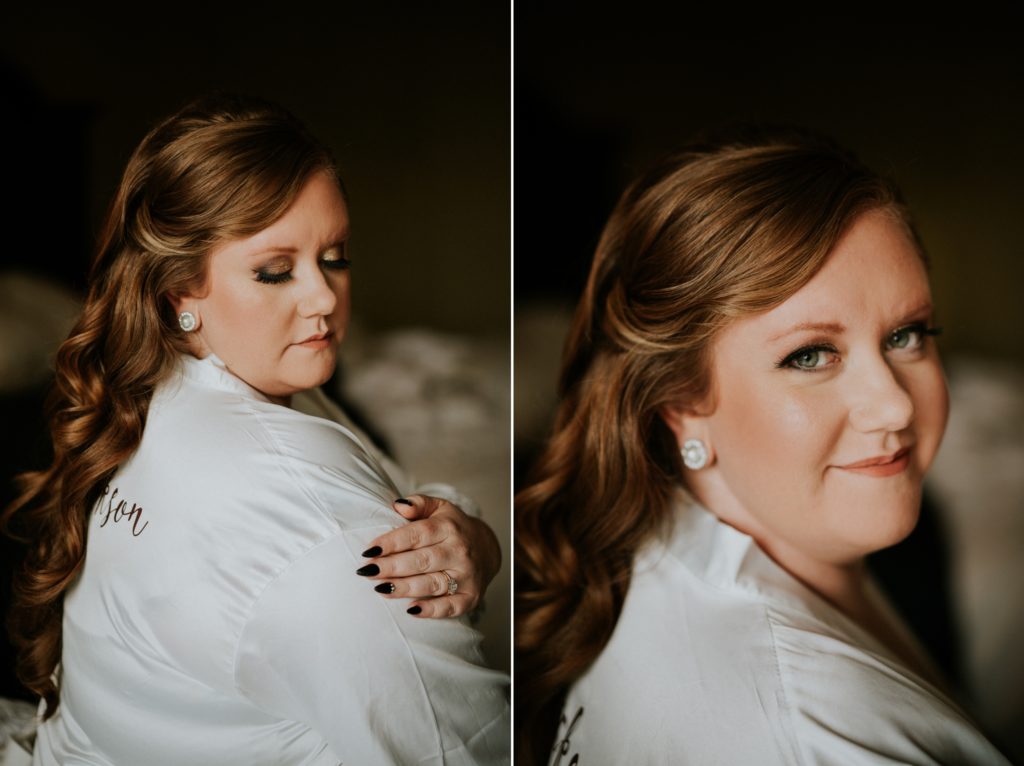 Redheaded bride shows off wedding makeup and black nails manicure in bridal robe