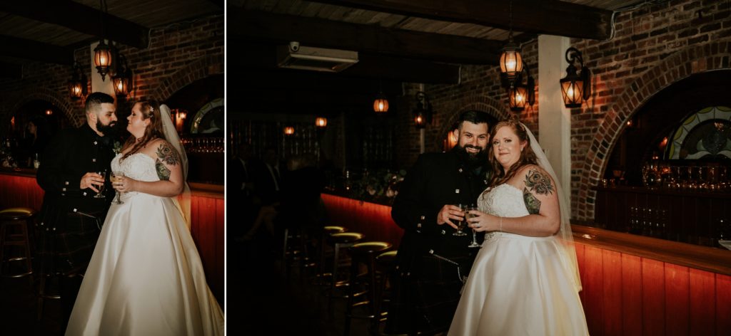 Groom and bride smile near the Historic Maxwell Room wedding venue bar with brick walls