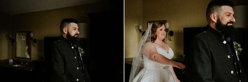 Scottish groom looks out window of hotel room as his future bride taps him on shoulder for first look