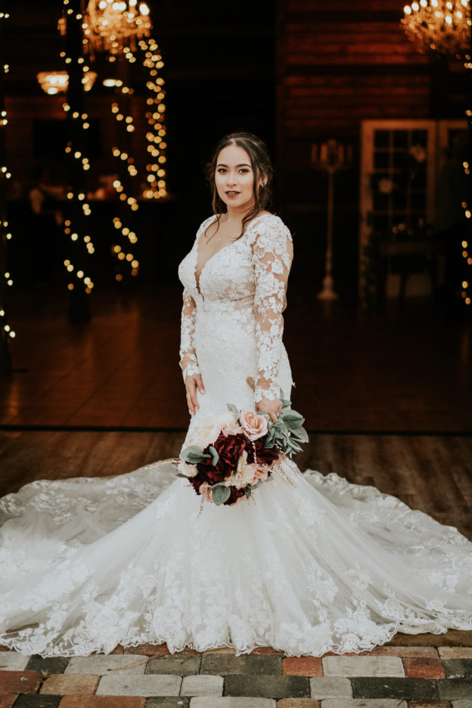 Floral lace appliqué beaded wedding dress for Florida bride with royal train by Martina Liana at Ever After Farms Ranch Barn FL