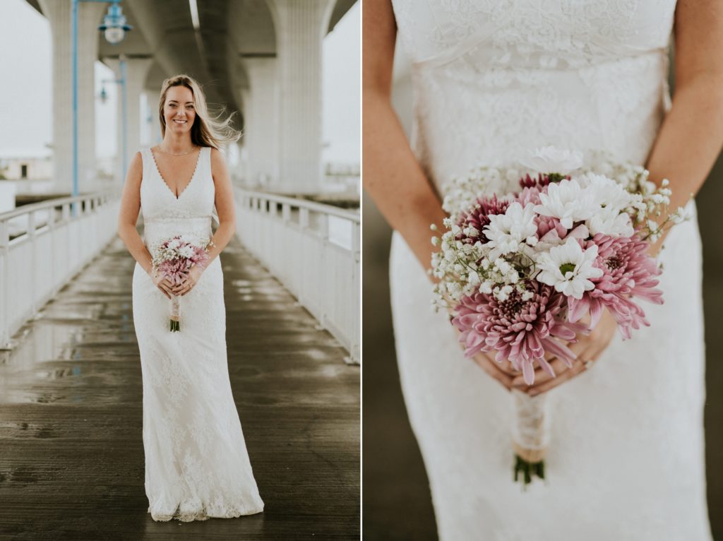 Bride holds pink and white bouquet under Roosevelt bridge in Downtown Stuart elopement
