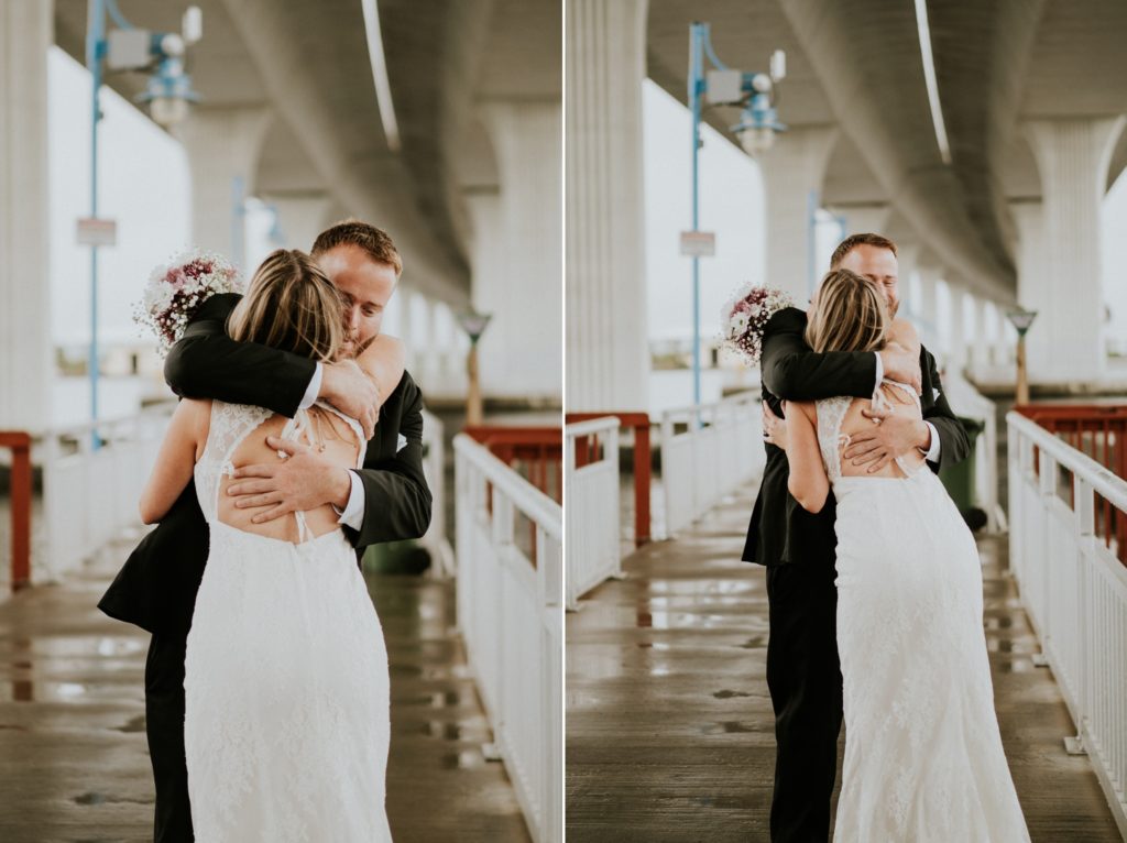 Bride and groom embrace first look under Roosevelt bridge Downtown Stuart FL wedding urban elopement