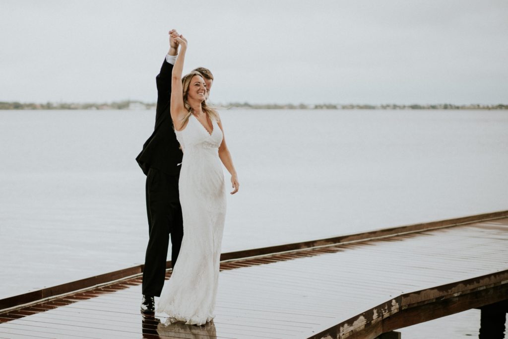 Bride and groom dance on Rockin' Riverwalk in background in Downtown Stuart FL elopement