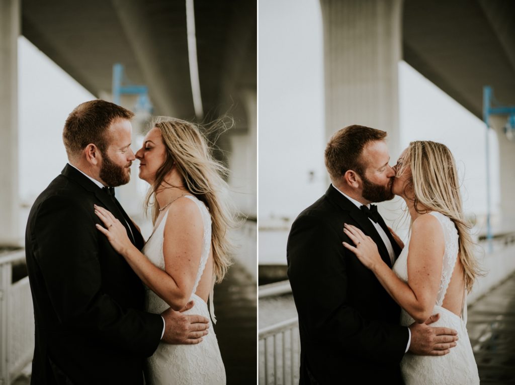 Bride and groom embrace for kiss under Roosevelt bridge in Downtown Stuart FL elopement