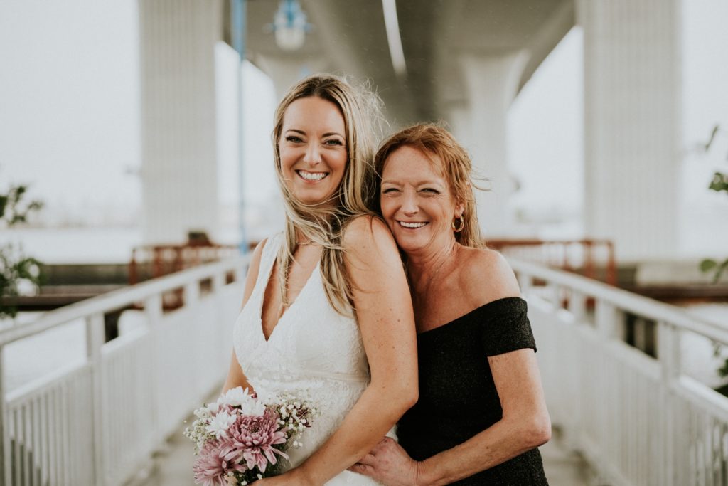 Bride and her mom smile for family photos in Stuart FL wedding