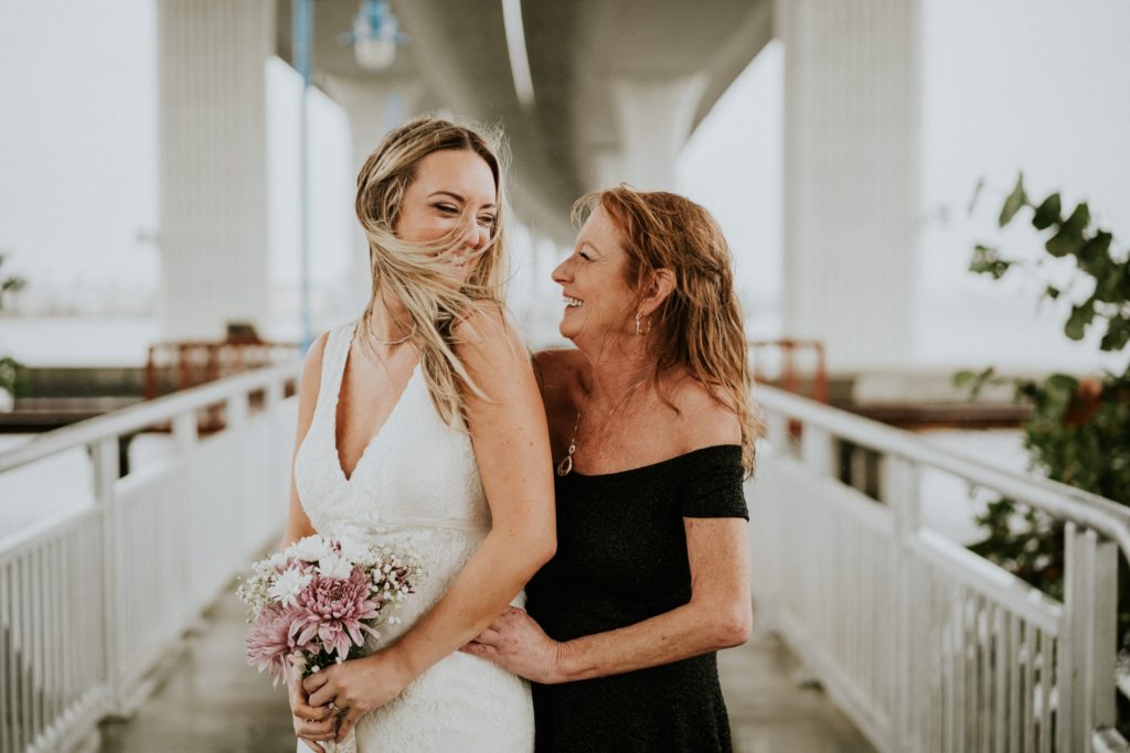 Bride looks at her mom on windy elopement day in Stuart FL