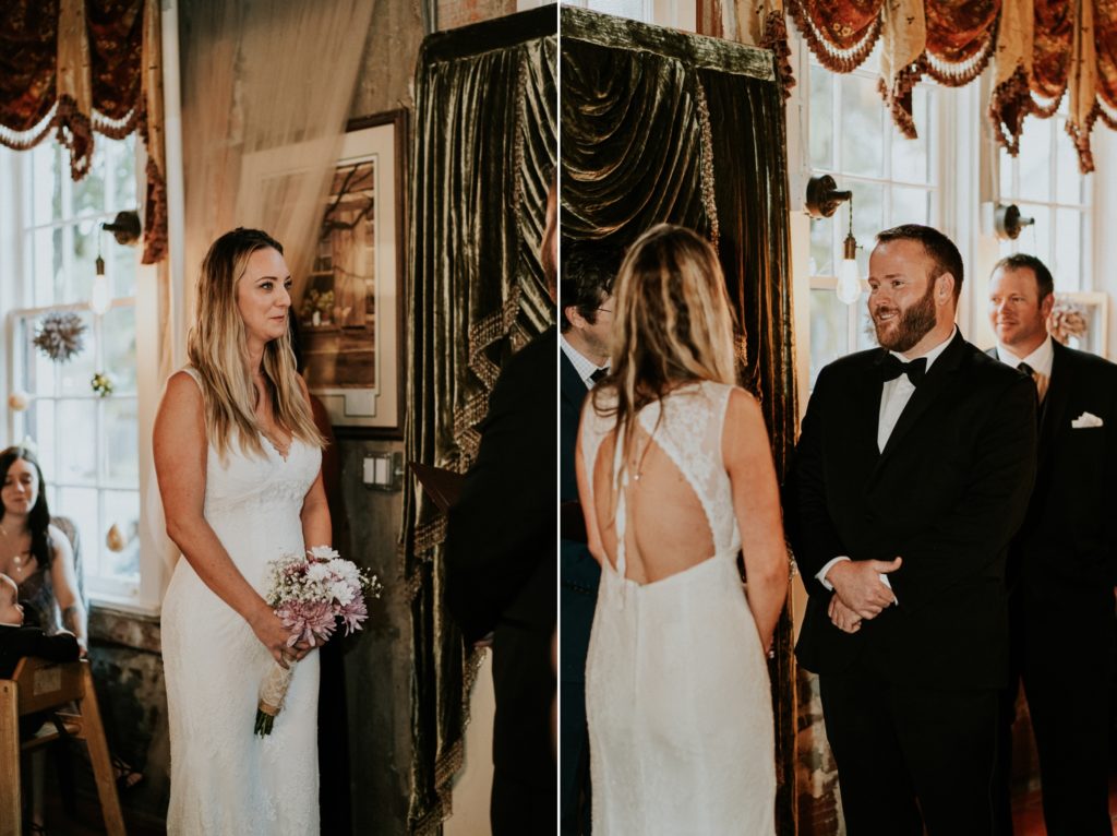 Bride and groom smile at each other during indoor wedding ceremony
