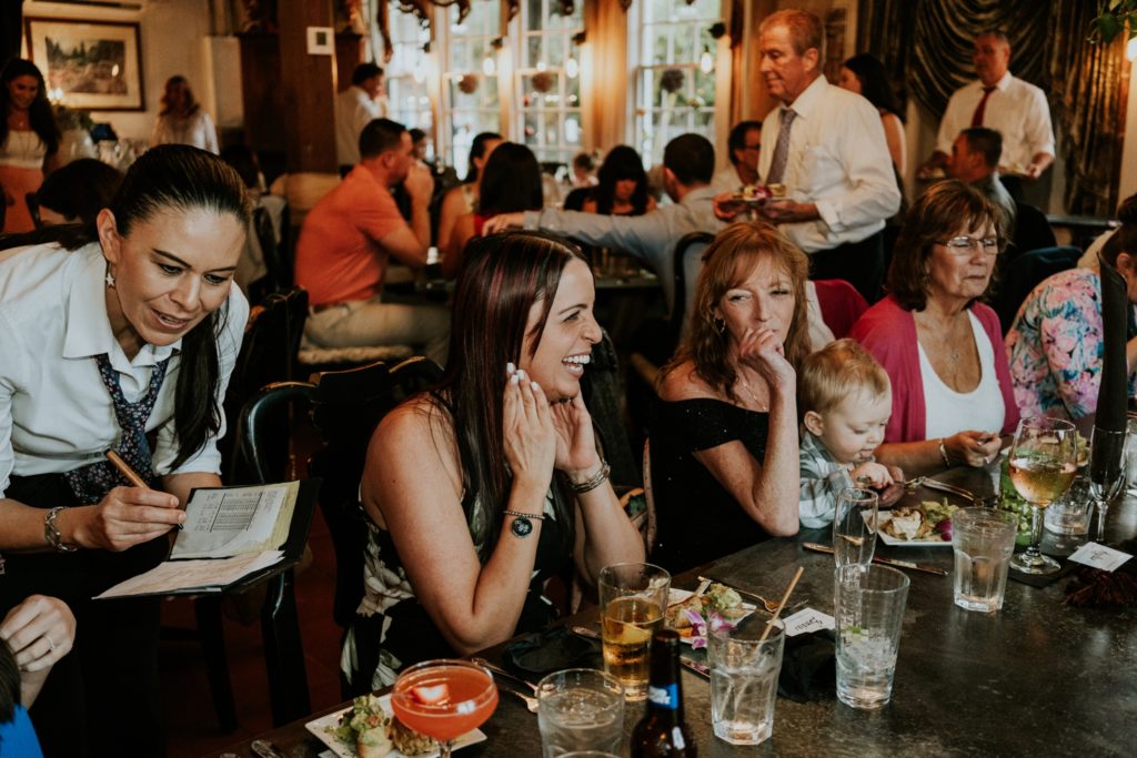 Cafe Martier waitress takes dinner orders from happy wedding guests