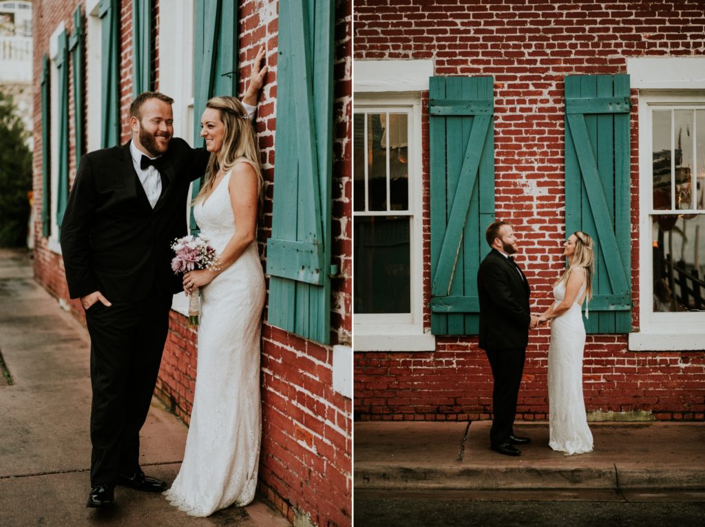 Groom and bride in front of red brick and green shutters of Riverwalk Cafe Downtown Stuart elopement