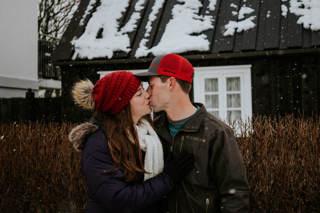 Reykjavík Iceland elopement couple kiss in snow in front of black house