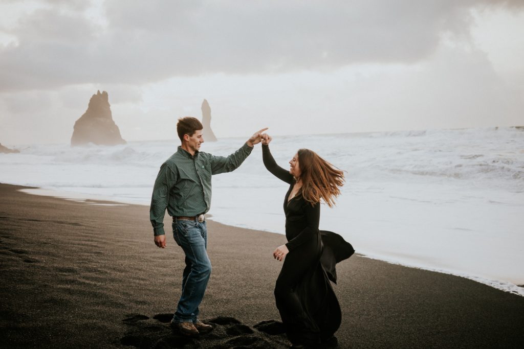 Couple dance on Black Sand Beach Vík
