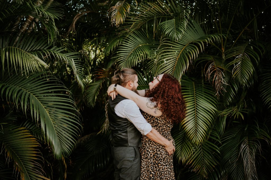 Matt & Nikki hug in backyard engagement West Palm Beach Worth Avenue FL