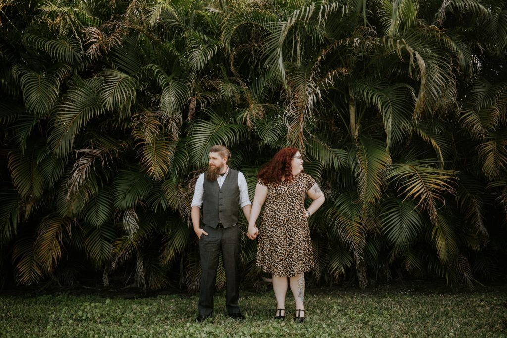 Matt & Nikki hold hands in backyard engagement West Palm Beach Worth Avenue FL