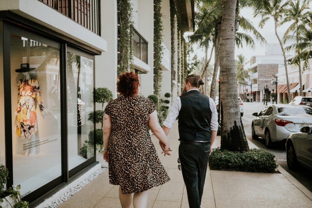 Engaged couple walks Worth Avenue Palm Beach