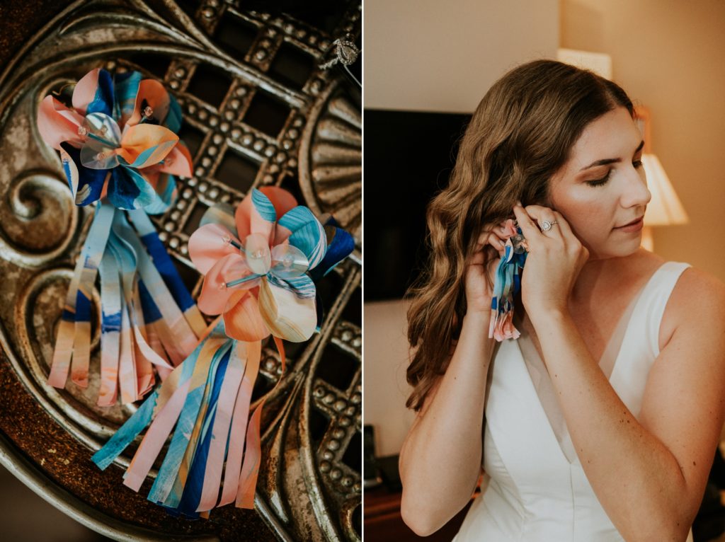 Bride puts on colorful blue orange earrings wedding details Florida wedding photography