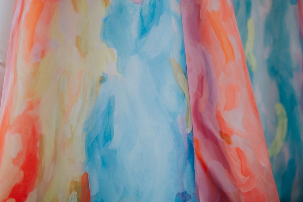 Colorful abstract rainbow hand-painted wedding dress close-up